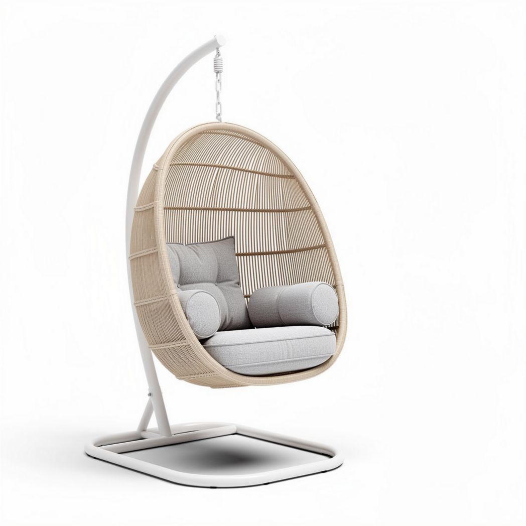 Hanging egg chair with comfortable cushions made of rattan and steel in cream color